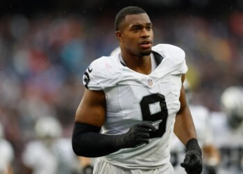 Football player wearing a white jersey with the number 9.