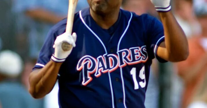 Tony Gwynn acknowledging the crowd, holding his helmet in one hand and a bat in the other.