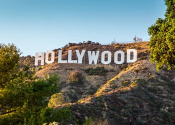 The Hollywood sign on a hill under a clear sky.