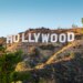 The Hollywood sign on a hill under a clear sky.