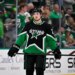 Dallas Stars left wing Jason Robertson in black and green uniform with his hockey stick.