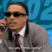 A man in a striped suit and sunglasses talks on the phone, saying "Hey, why is Philly coming?"