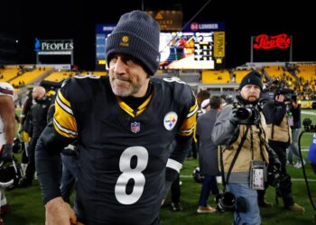 Aaron Rodgers walks off the field after the Steelers' playoff loss to the Texans.