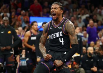 Jalen Green, who scored a game-high 36 points, celebrates after slamming home a dunk during the first half of the Suns' 111-96 win over the Warriors on April 17, 2026 in an NBA play-in game in Phoenix.