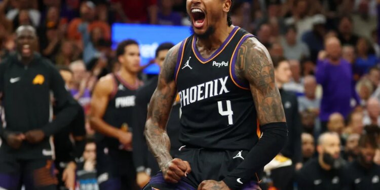 Jalen Green, who scored a game-high 36 points, celebrates after slamming home a dunk during the first half of the Suns' 111-96 win over the Warriors on April 17, 2026 in an NBA play-in game in Phoenix.