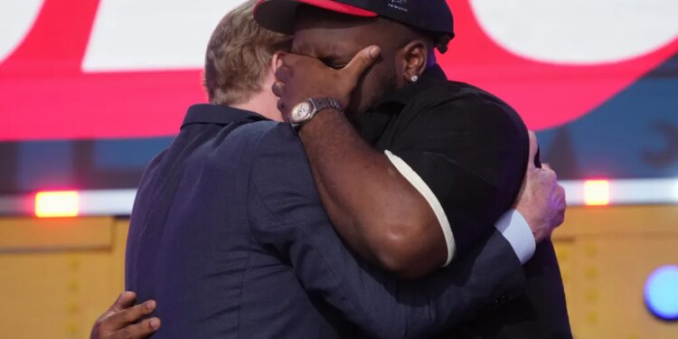 Kayden McDonald, right, reacts with NFL Commissioner Roger Goodell after being chosen by the Houston Texans with the 36th overall pick during the second round of the NFL football draft, Friday, April 24, 2026.