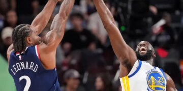 Kawhi Leonard shooting over Draymond Green during a basketball game.