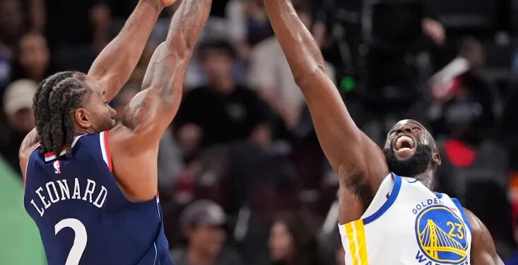 Kawhi Leonard shooting over Draymond Green during a basketball game.