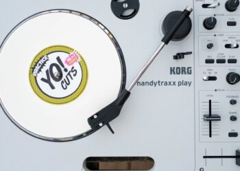The Korg Handytraxx Play portable turntable on a beat up piece of deck furniture.