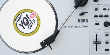 The Korg Handytraxx Play portable turntable on a beat up piece of deck furniture.