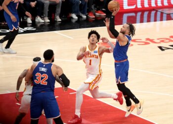 Knicks guard Jalen Brunson (11) goes up for a shot as Atlanta Hawks forward Jalen Johnson (1) gives chase during the fourth quarter.