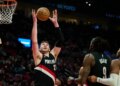 Portland Trail Blazers center Donovan Clingan (23) grabs a rebound during the second half against the Dallas Mavericks at Moda Center.