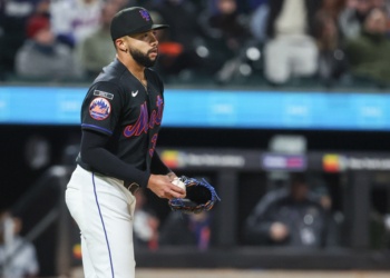 New York Mets relief pitcher Devin Williams (38) reacts after walking in a run.