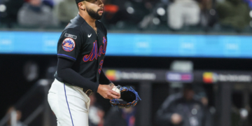 New York Mets relief pitcher Devin Williams (38) reacts after walking in a run.