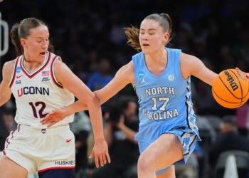Ashlynn Shade (UConn) and Elina Aarnisalo (North Carolina) playing basketball.