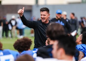 Bob Chesney giving a thumbs up and shouting encouragement during April 2026 spring practice.