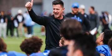 Bob Chesney giving a thumbs up and shouting encouragement during April 2026 spring practice.