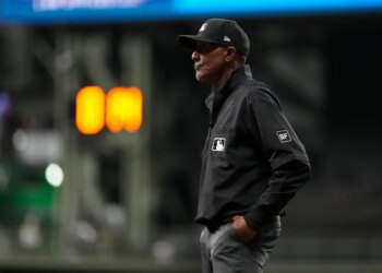 Umpire CB Bucknor looks on during the eighth inning of a baseball game between the Milwaukee Brewers and the Tampa Bay Rays, Tuesday, March 31, 2026, in Milwaukee.