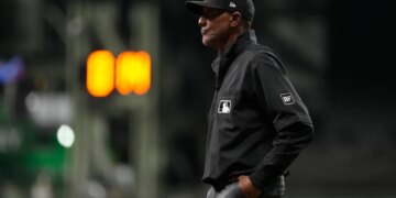 Umpire CB Bucknor looks on during the eighth inning of a baseball game between the Milwaukee Brewers and the Tampa Bay Rays, Tuesday, March 31, 2026, in Milwaukee.