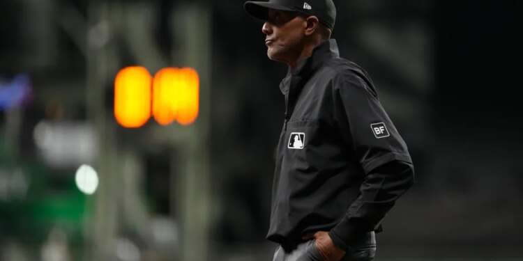 Umpire CB Bucknor looks on during the eighth inning of a baseball game between the Milwaukee Brewers and the Tampa Bay Rays, Tuesday, March 31, 2026, in Milwaukee.