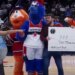A fan posing for a photo with the Washington Wizards mascots and a fake check for $10,000 for an April Fool's Day prank.