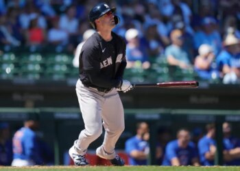 Yankees' Randal Grichuk watches the flight of his home run against the Chicago Cubs during the fourth inning of a spring training baseball game, Tuesday, March 24, 2026.