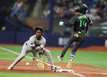 Rays left fielder Chandler Simpson (14) runs out a single past Yankees second baseman Jazz Chisholm Jr. (13) in the tenth inning on April 11, 2026.