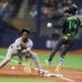 Rays left fielder Chandler Simpson (14) runs out a single past Yankees second baseman Jazz Chisholm Jr. (13) in the tenth inning on April 11, 2026.