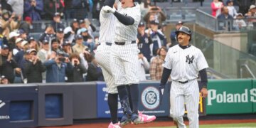 New York Yankees first baseman Ben Rice (22) celebrates with New York Yankees right fielder Aaron Judge (99) after he scores on his three-run homer.