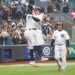 New York Yankees first baseman Ben Rice (22) celebrates with New York Yankees right fielder Aaron Judge (99) after he scores on his three-run homer.