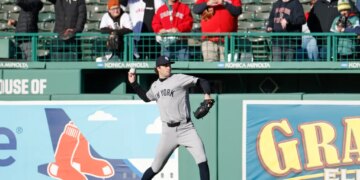 New York Yankees pitcher Cam Schlittler warms up on the field during batting practice.