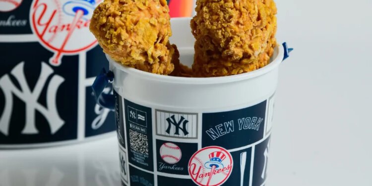 Two pieces of fried chicken in a New York Yankees branded cup.