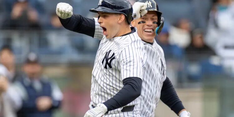New York Yankees first baseman Ben Rice (22) celebrates with New York Yankees right fielder Aaron Judge (99) after he scores on his solo homer.