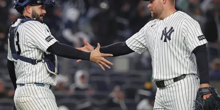 David Bednar celebrates with Austin Wells after closing out the Yankees' 5-3 comeback win over the A's on April 7, 2026 at the Stadium.