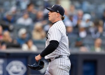 New York Yankees pitcher Ryan Weathers walks towards the dugout after the third inning.