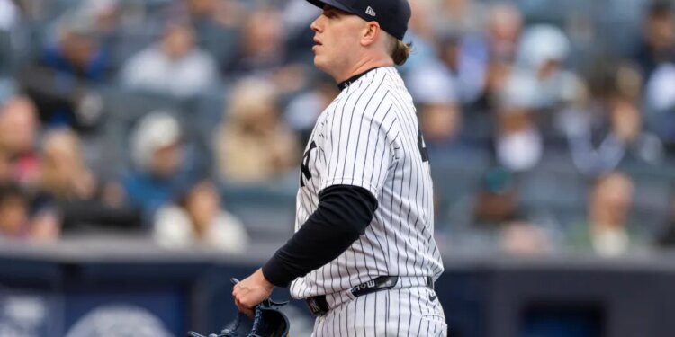 New York Yankees pitcher Ryan Weathers walks towards the dugout after the third inning.