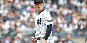 New York Yankees pitcher Will Warren (29) reacts as he walks back to the dugout after ending the first inning.
