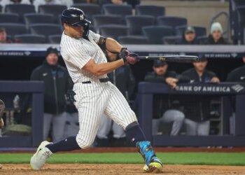 New York Yankees designated hitter Giancarlo Stanton (27) hitting a single.