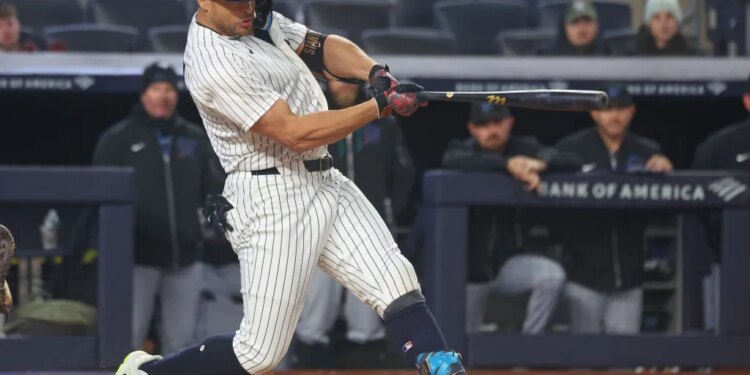 New York Yankees designated hitter Giancarlo Stanton (27) hitting a single.