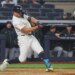 New York Yankees designated hitter Giancarlo Stanton (27) hitting a single.