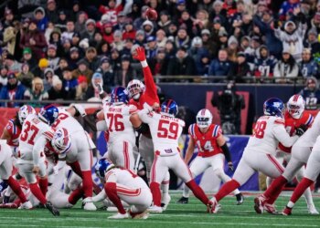 New York Giants kicker Younghoe Koo (37) kicks during the first half of an NFL football game against the New England Patriots.