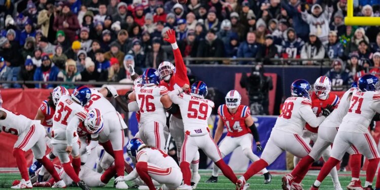 New York Giants kicker Younghoe Koo (37) kicks during the first half of an NFL football game against the New England Patriots.