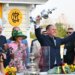 Chad C. Brown, trainer of horse Early Voting, holds the Woodland Vase after his horse won the 147th running of the Preakness Stakes.