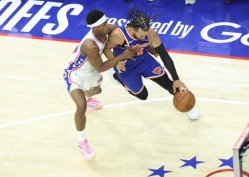 New York Knicks guard Jalen Brunson #11 drives to the basket as Philadelphia 76ers guard Vj Edgecombe #77 gives chase.