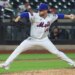 New York Mets pitcher throwing a baseball during a game against the Cincinnati Reds.
