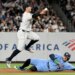 Yankees shortstop Anthony Volpe jumps over Blue Jays designated hitter George Springer during a double play.