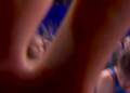 Alex Caruso pushing a camera away from a basketball huddle.