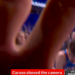 Alex Caruso pushing a camera away from a basketball huddle.