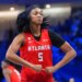 Angel Reese of the Atlanta Dream flexes after scoring during a WNBA basketball game.