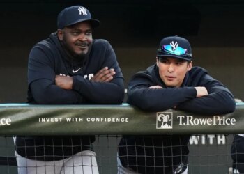 Anthony Volpe (r.) watches from the Yankees dugout during a game against the Orioles on May 12, 2026.